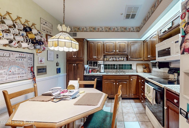 kitchen with electric range, visible vents, dishwasher, white microwave, and a sink