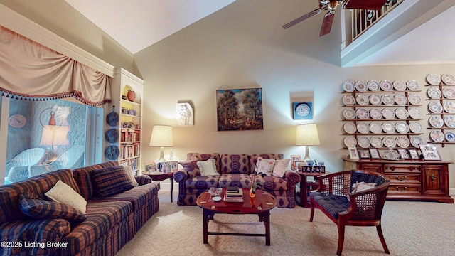 carpeted living room featuring high vaulted ceiling and ceiling fan