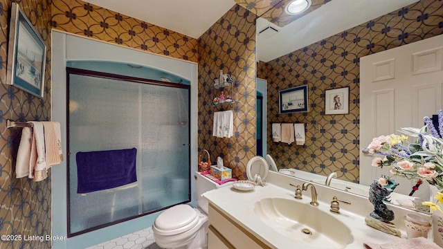 bathroom featuring visible vents, vanity, toilet, and wallpapered walls