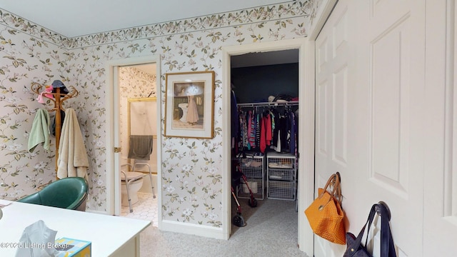 office area featuring light colored carpet, baseboards, and wallpapered walls