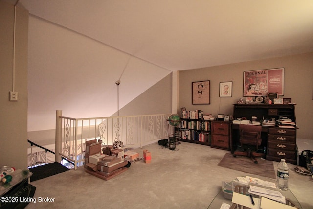 interior space featuring vaulted ceiling and carpet