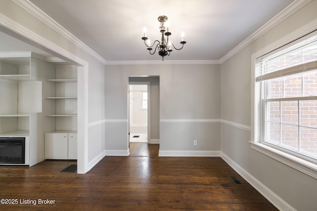 unfurnished dining area with ornamental molding, visible vents, a chandelier, wood finished floors, and baseboards