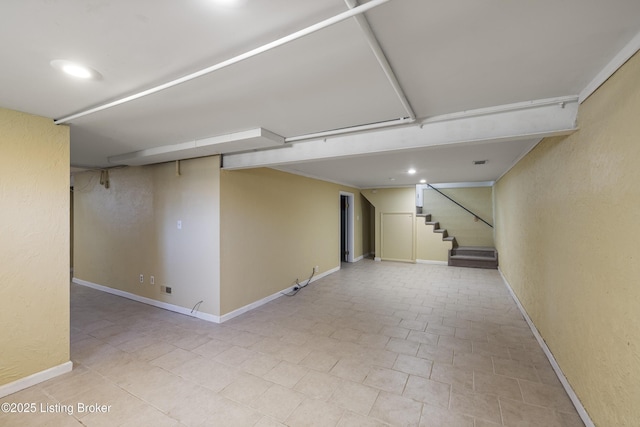finished basement featuring recessed lighting, stairway, and baseboards