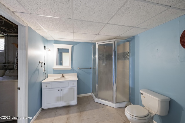 full bath featuring vanity, toilet, washer / dryer, a stall shower, and tile patterned floors