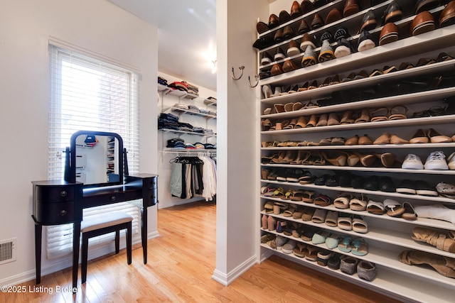 spacious closet featuring visible vents and light wood-style flooring