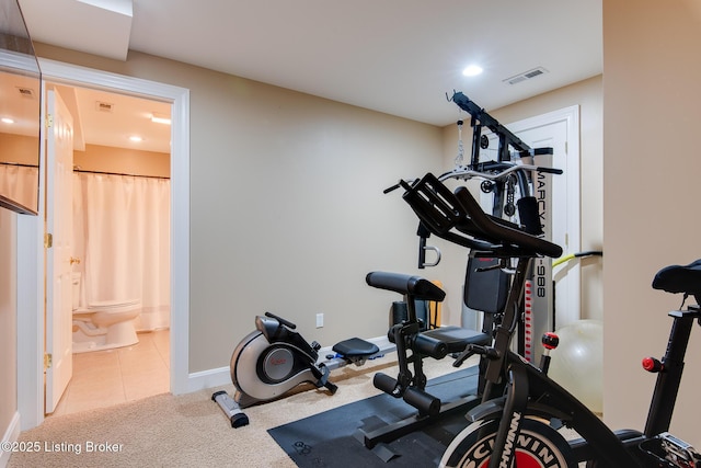 exercise area featuring carpet floors, baseboards, visible vents, and tile patterned floors