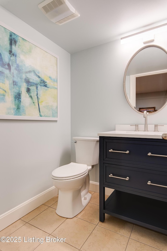 half bathroom featuring toilet, vanity, baseboards, visible vents, and tile patterned floors