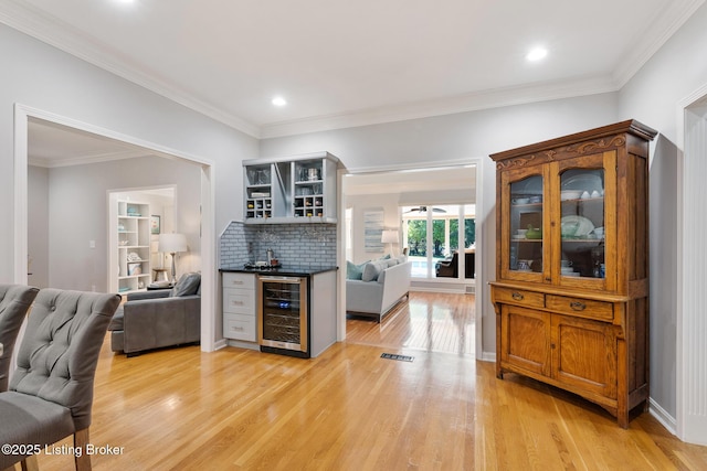 kitchen featuring light wood-style flooring, beverage cooler, open floor plan, open shelves, and dark countertops