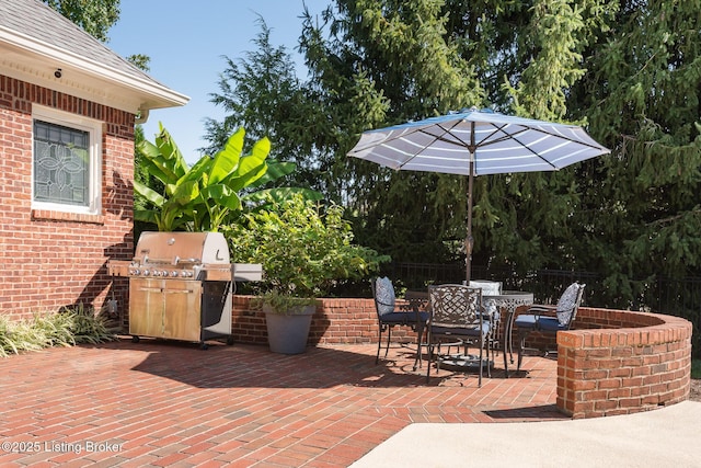 view of patio / terrace with area for grilling, outdoor dining area, grilling area, and fence