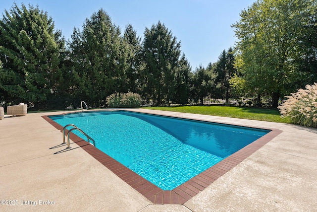 pool featuring a patio and a yard