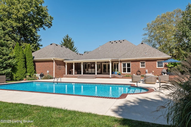 pool featuring a patio area and a sunroom