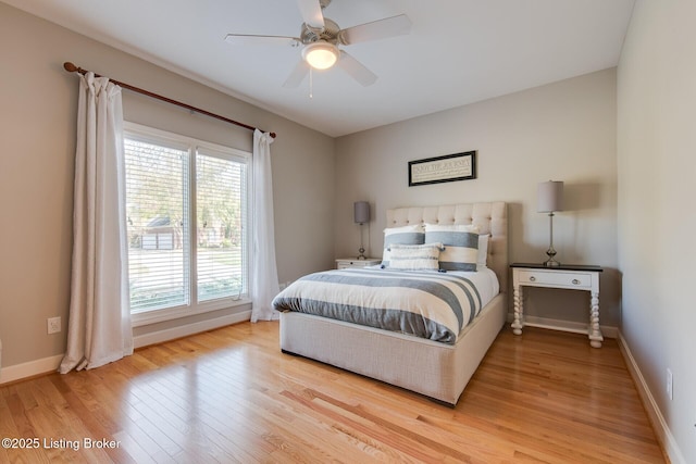 bedroom featuring wood finished floors, a ceiling fan, and baseboards