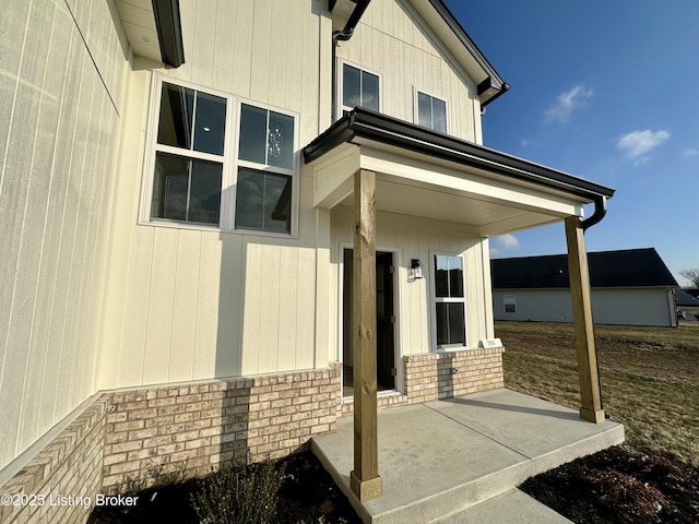 entrance to property featuring brick siding