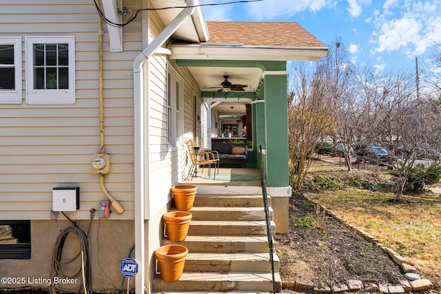 property entrance with a shingled roof and a porch