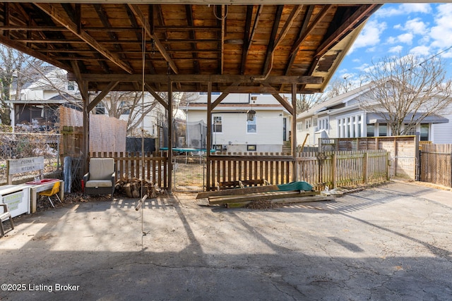 view of patio / terrace with a trampoline and fence