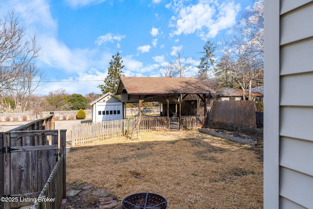 view of yard with fence and an outbuilding