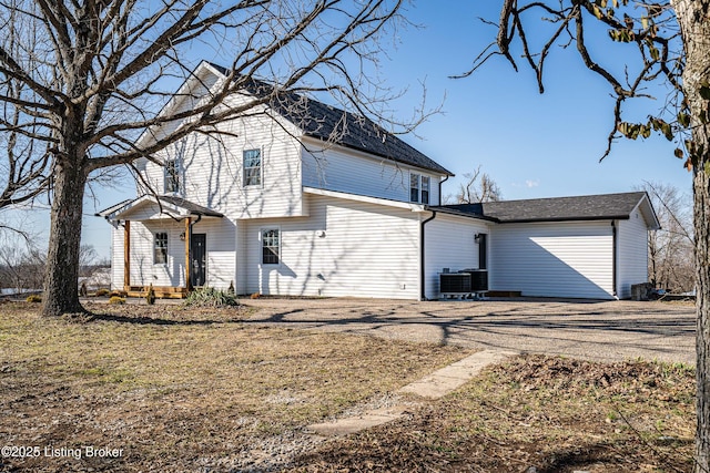 view of property exterior featuring dirt driveway and cooling unit