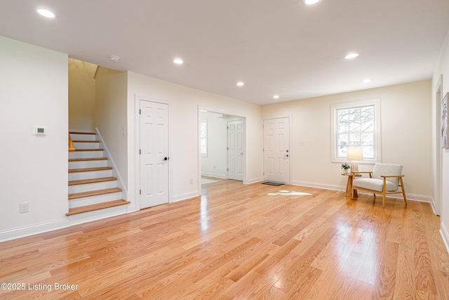 interior space with stairs, light wood-type flooring, baseboards, and recessed lighting