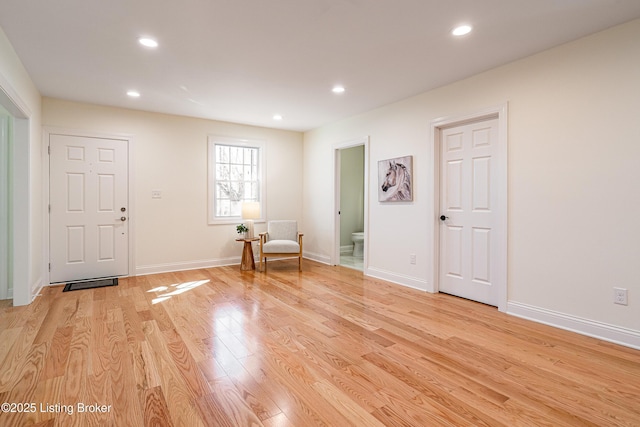 interior space with light wood-type flooring, baseboards, and recessed lighting