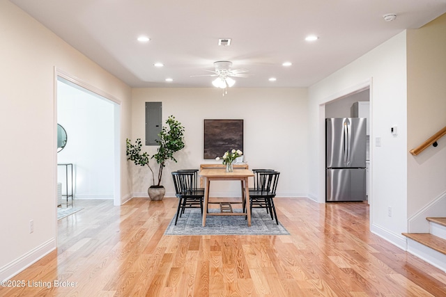 dining room with stairs, light wood finished floors, baseboards, and recessed lighting