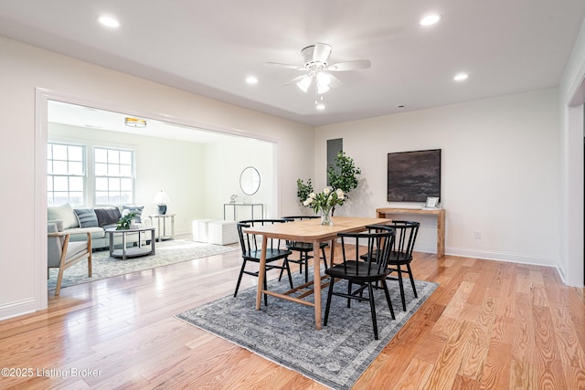 dining room featuring baseboards, ceiling fan, light wood finished floors, and recessed lighting