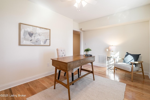 home office with light wood-type flooring, baseboards, and visible vents