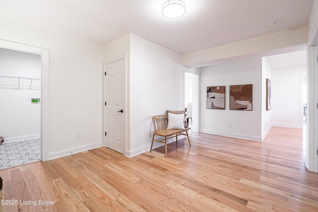 unfurnished room featuring light wood-type flooring and baseboards