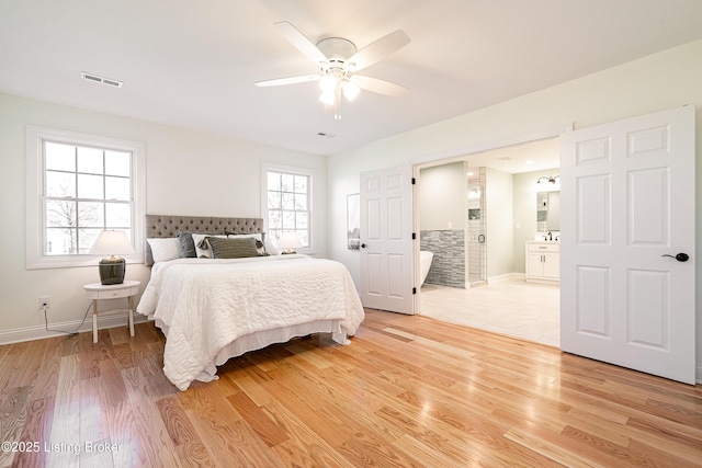 bedroom featuring visible vents, light wood-style flooring, and baseboards