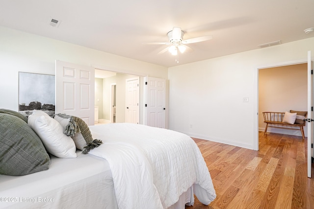 bedroom with visible vents, ceiling fan, light wood-style flooring, and baseboards