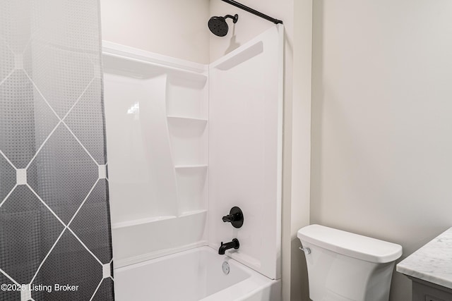 bathroom featuring toilet, tub / shower combination, and vanity