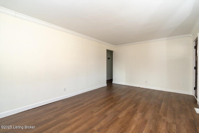 spare room with baseboards, dark wood-style flooring, and crown molding