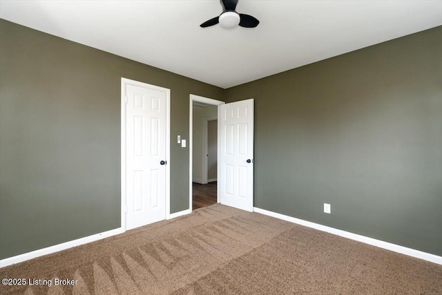 unfurnished bedroom with ceiling fan, carpet flooring, and baseboards