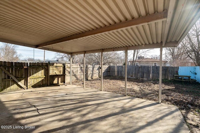 view of patio / terrace featuring a fenced backyard and a carport