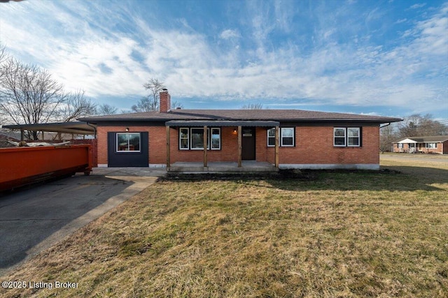 ranch-style house with brick siding, driveway, a carport, a chimney, and a front yard