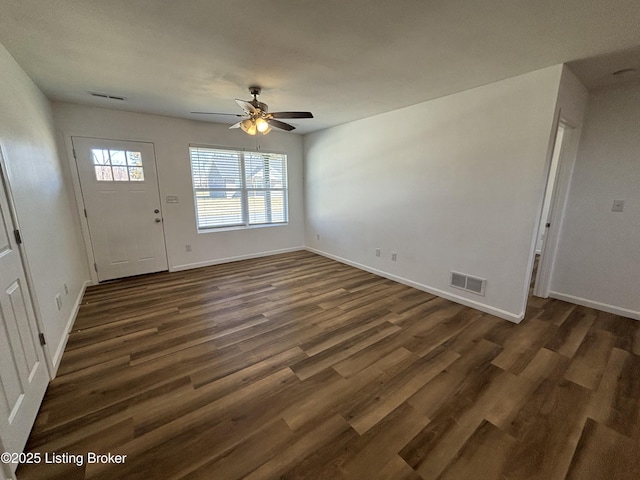 entryway with dark wood-type flooring, visible vents, and baseboards