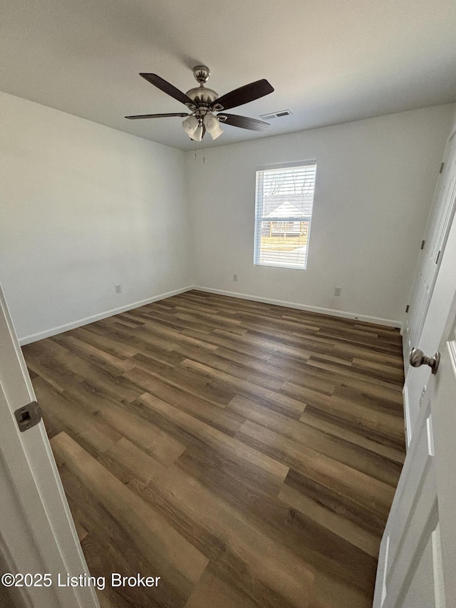 unfurnished bedroom with dark wood-style flooring, visible vents, and baseboards