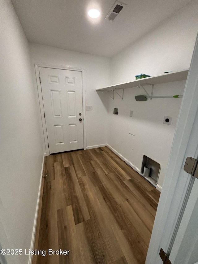 laundry room featuring hookup for an electric dryer, laundry area, dark wood-type flooring, visible vents, and baseboards