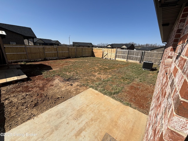 view of yard featuring a patio, a fenced backyard, and cooling unit