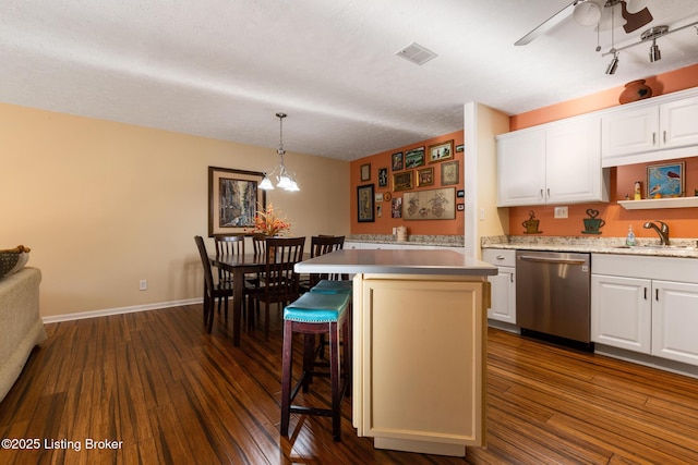 kitchen featuring a sink, visible vents, white cabinets, dark wood-style floors, and dishwasher