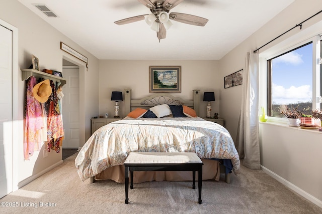 bedroom featuring light carpet, baseboards, visible vents, and ceiling fan