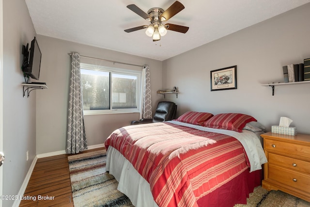 bedroom with a ceiling fan, baseboards, and wood finished floors