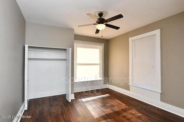 unfurnished bedroom featuring ceiling fan, wood finished floors, and baseboards