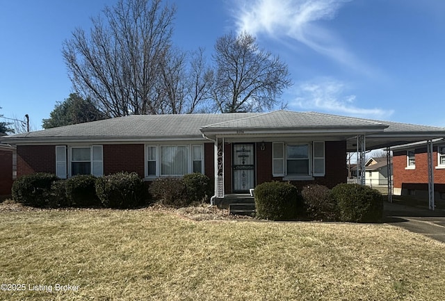 ranch-style home with an attached carport, a front yard, and brick siding