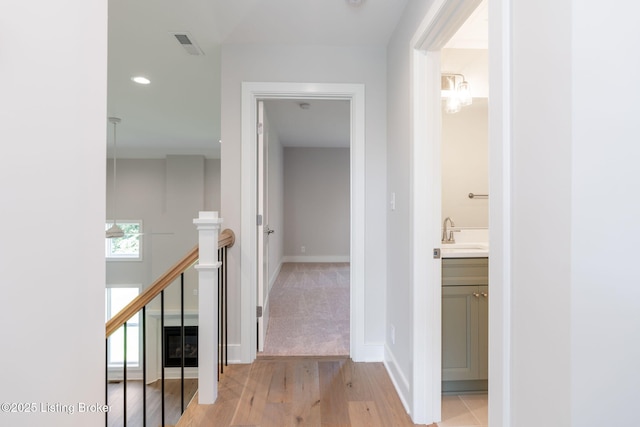 3314 Catalpa Farms Dr, Fisherville, KY 40023 - hall featuring an upstairs landing, a sink, light wood finished floors, recessed lighting, and baseboards