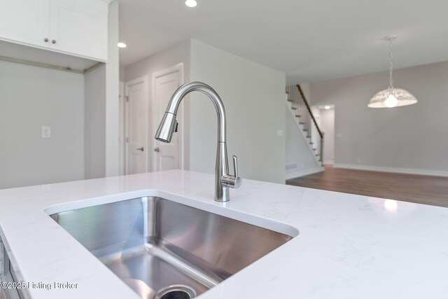 3314 Catalpa Farms Dr, Fisherville, KY 40023 - kitchen view of a sink, recessed lighting, wood finished floors, pendant lighting, and white cabinets