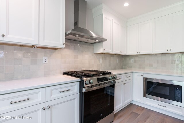 3314 Catalpa Farms Dr, Fisherville, KY 40023 - kitchen featuring stainless steel gas range, wall chimney range hood, built in microwave, light countertops, and white cabinetry