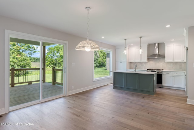 3314 Catalpa Farms Dr, Fisherville, KY 40023 - kitchen with wall chimney range hood, stainless steel gas range, light countertops, baseboards, and light wood-style flooring