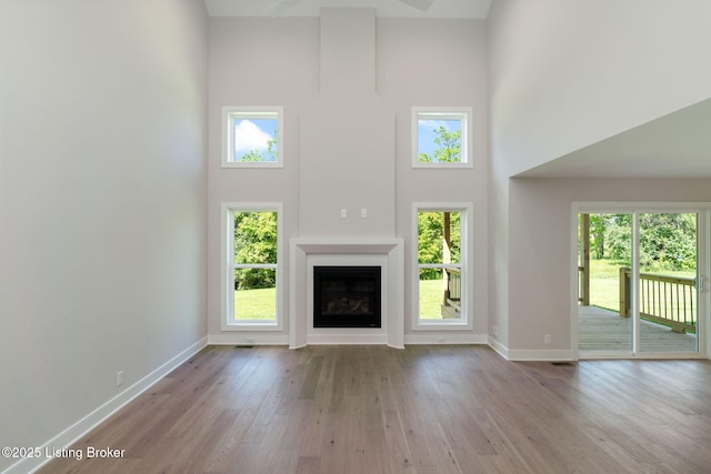 3314 Catalpa Farms Dr, Fisherville, KY 40023 - unfurnished living room with a high ceiling, wood finished floors, baseboards, a fireplace, and healthy amount of natural light