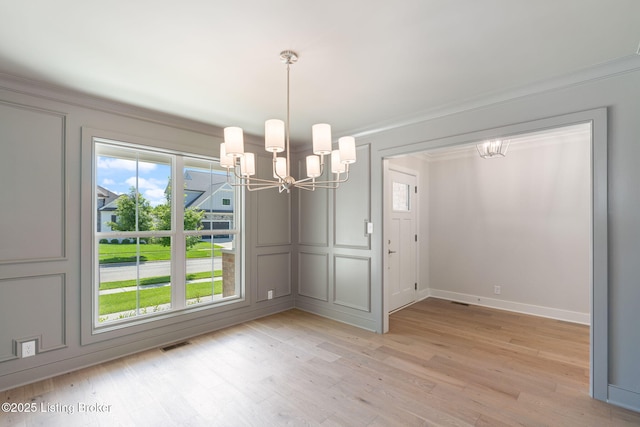 3314 Catalpa Farms Dr, Fisherville, KY 40023 - unfurnished dining area with a chandelier, a decorative wall, light wood-style flooring, ornamental molding, and baseboards