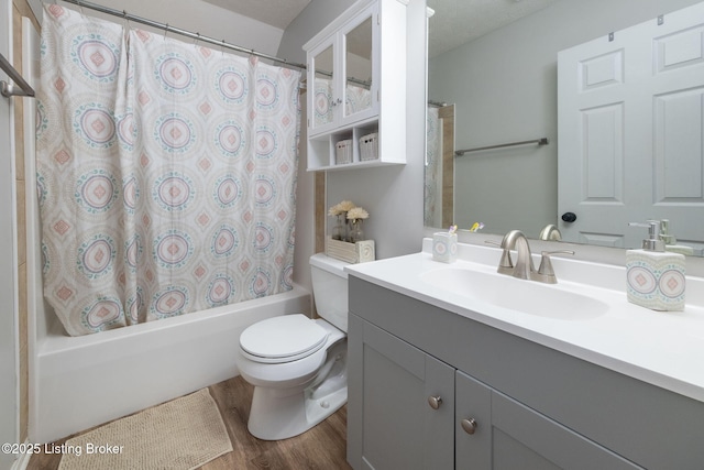 bathroom with toilet, shower / tub combo, wood finished floors, and vanity